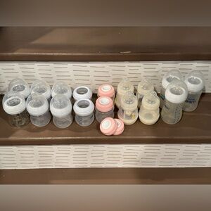 Lot of 17 Avent and Mam bottles and bottle stoppers